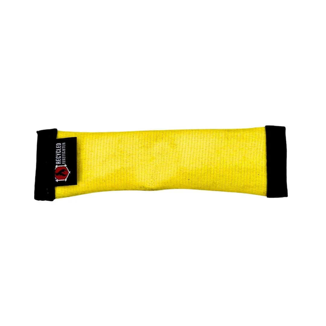 Yellow dog toy with black ends on a white background